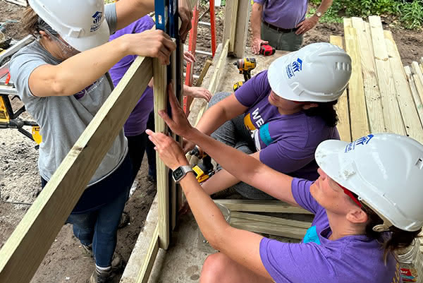 Romina Egan and team working on a Habitat for Humanity jobsite, building a deck.